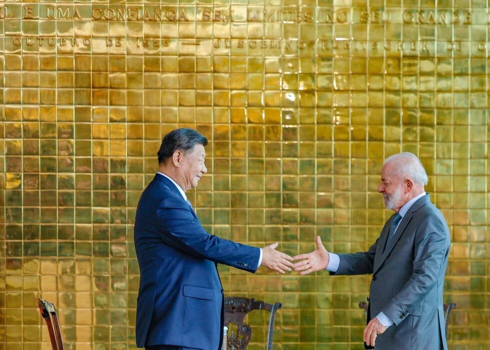 GPT Icon Foto: Der chinesische Präsident Xi Jinping und der brasilianische Präsident Luiz Inácio Lula da Silva schütteln sich die Hände vor einer goldfarbenen Wand.